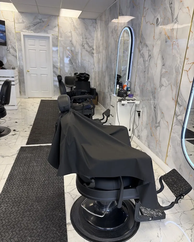 CUTCREW barbershop interior with marble walls and LED mirrors